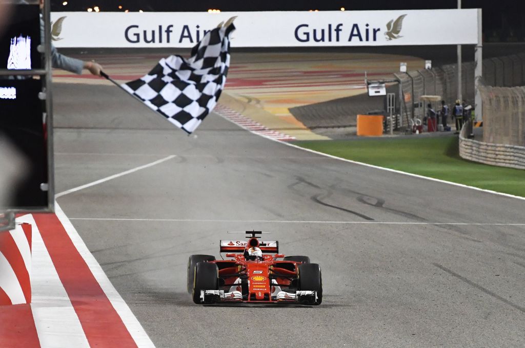 Ferrari's German driver Sebastian Vettel drives his car past the chequered flag to win the Bahrain Formula One Grand Prix at the Sakhir circuit in Manama on April 16, 2017.  / AFP PHOTO / POOL / ANDREJ ISAKOVIC        (Photo credit should read ANDREJ ISAKOVIC/AFP/Getty Images)