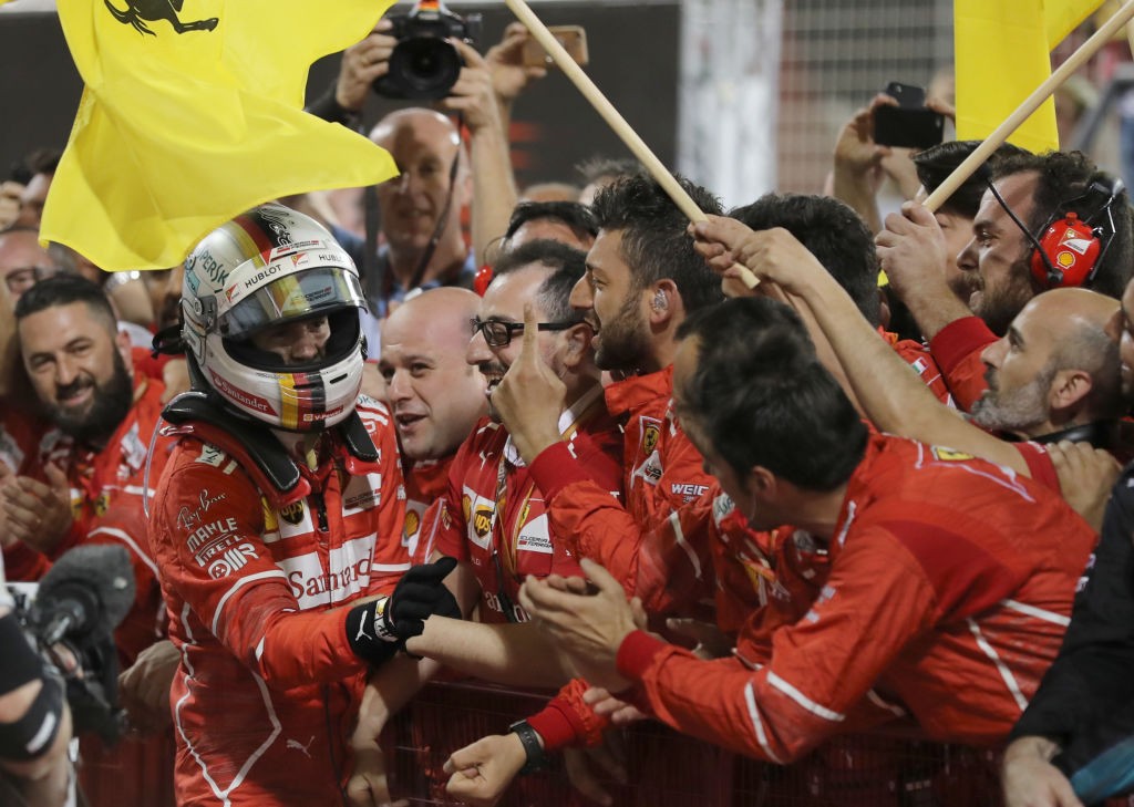 Ferrari's German driver Sebastian Vettel celebrates after winning the Bahrain Formula One Grand Prix at the Sakhir circuit in Manama on April 16, 2017 / AFP PHOTO / KARIM SAHIB        (Photo credit should read KARIM SAHIB/AFP/Getty Images)