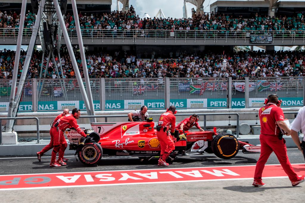 Team members push Ferrari's Finland driver Kimi Raikkonen's car into the garage during the Formula One Malaysia Grand Prix in Sepang on October 1, 2017. / AFP PHOTO / POOL / AHMAD YUSNI        (Photo credit should read AHMAD YUSNI/AFP/Getty Images)