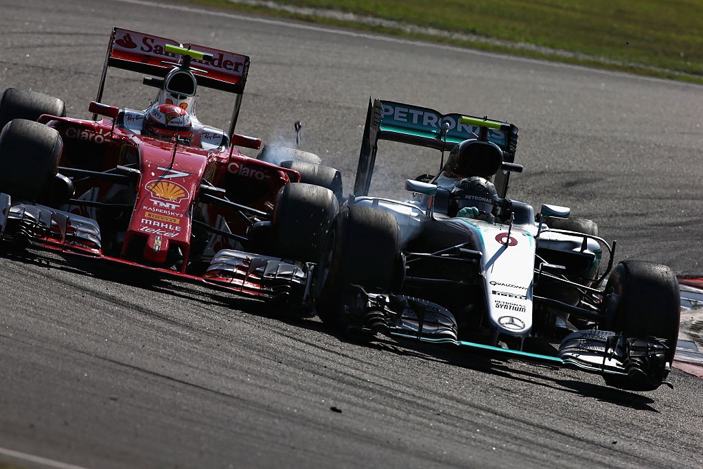 KUALA LUMPUR, MALAYSIA - OCTOBER 02: Nico Rosberg of Germany driving the (6) Mercedes AMG Petronas F1 Team Mercedes F1 WO7 Mercedes PU106C Hybrid turbo and Kimi Raikkonen of Finland driving the (7) Scuderia Ferrari SF16-H Ferrari 059/5 turbo (Shell GP) clash on track during the Malaysia Formula One Grand Prix at Sepang Circuit on October 2, 2016 in Kuala Lumpur, Malaysia. (Photo by Charles Coates/Getty Images)