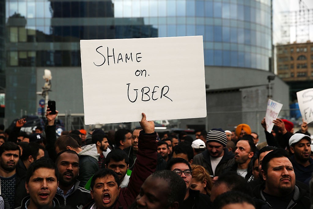 NEW YORK, NY - FEBRUARY 01:  Uber drivers protest  the company's recent fare cuts and go on strike in front of the car service's New York offices on February 1, 2016 in New York City. The drivers say Uber continues to cut into their earnings without cutting into its own take from each ride. In claiming fare reduction would mean more work for drivers, the San Francisco based company cut its prices by 15 percent last week.  (Photo by Spencer Platt/Getty Images)