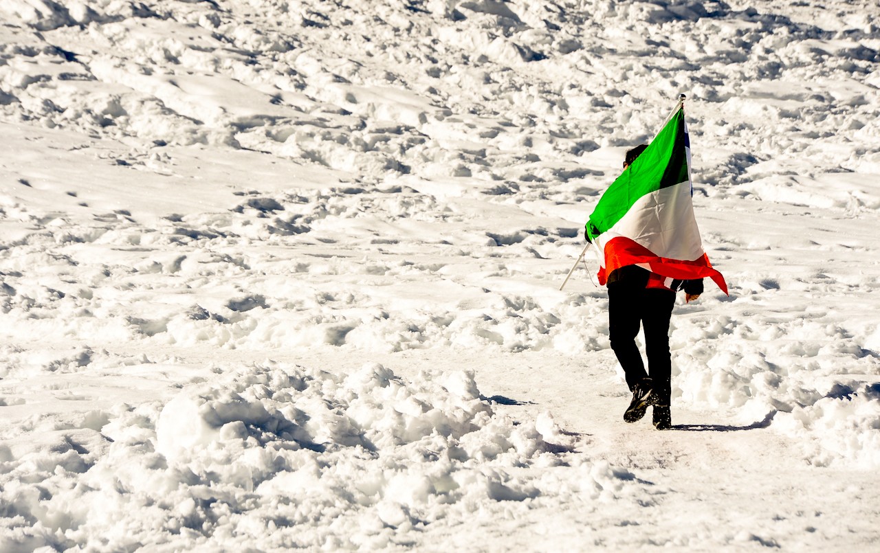 An Italy supporter holds an Italian flag on March 2, 2013 during the Women's Cross Country 30 km Classic race of the FIS Nordic World Ski Championships at Val Di Fiemme Cross Country stadium in Cavalese, northern Italy. AFP PHOTO / ANDREAS SOLARO        (Photo credit should read ANDREAS SOLARO/AFP/Getty Images)