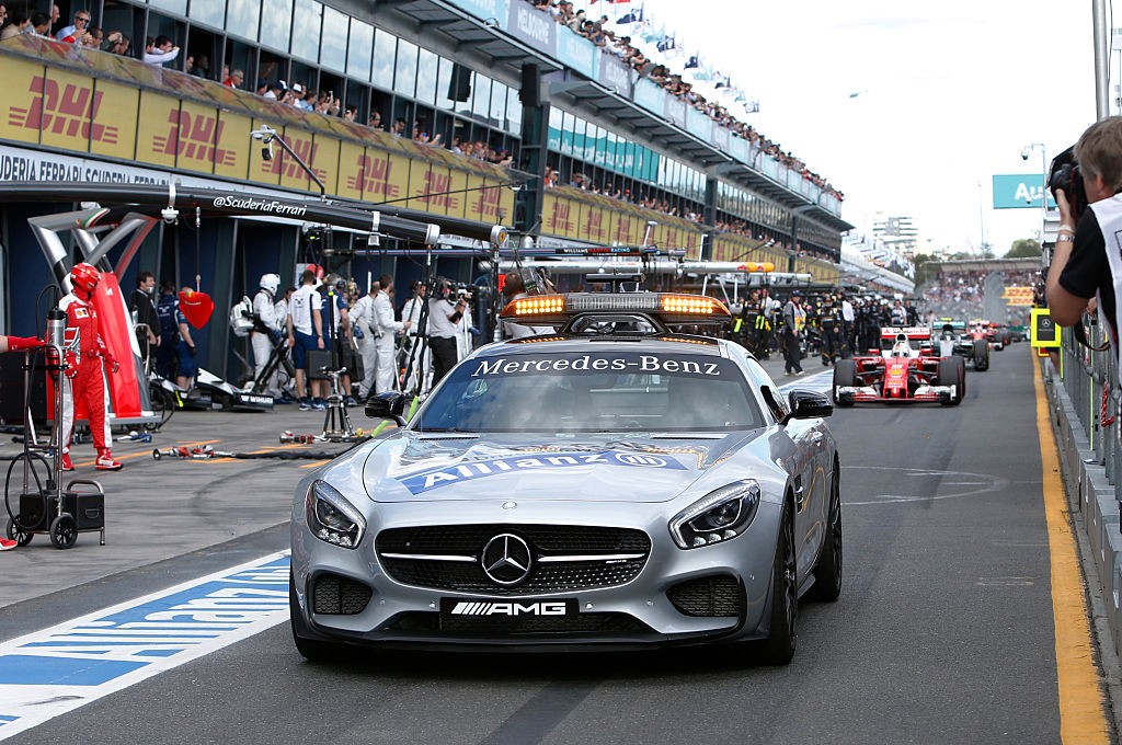 The safety car leads Formula One cars down the pit lane as a temporary suspension on the race was lifted following a crash between McLaren Honda's Spanish driver Fernando Alonso and Haas F1 Team's Brazilian driver Esteban Gutierrez during the Formula One Australian Grand Prix in Melbourne on March 20, 2016. / AFP / POOL / BRANDON MALONE / IMAGE STRICTLY RESTRICTED TO EDITORIAL USE  STRICTLY NO COMMERCIAL USE        (Photo credit should read BRANDON MALONE/AFP/Getty Images)